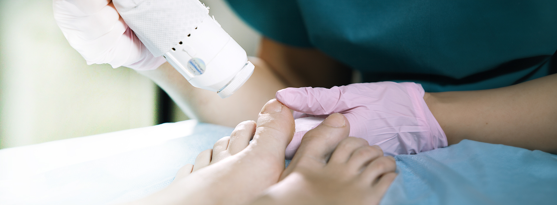 A person applying a substance to someone s foot, possibly in a medical or beauty context.